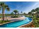 Lazy river with lounge chairs, tables, and landscaping at 3151 Paradox Cir # 201, Kissimmee, FL 34746