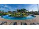 Relaxing lazy river winding through lush landscaping and poolside seating at 3151 Paradox Cir # 201, Kissimmee, FL 34746