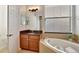 Bathroom with soaking tub, vanity, and dark countertop at 4437 Azure Isle Way, Kissimmee, FL 34744