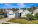 One-story home with light-blue painted walls, landscaping, and a two-car garage at 4437 Azure Isle Way, Kissimmee, FL 34744