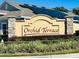 Orchid Terrace community entrance sign with landscaping and solar panels at 860 Teton St, Haines City, FL 33844