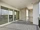 Spacious balcony with composite decking and stone accent wall, offering an outdoor retreat at 9778 Bucklow Hill Dr, Orlando, FL 32832