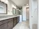 Elegant bathroom with double vanity, granite countertop and a large shower at 9778 Bucklow Hill Dr, Orlando, FL 32832