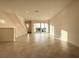 Bright living room with access to a balcony and water views at 9778 Bucklow Hill Dr, Orlando, FL 32832