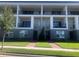 Modern three-story townhouses with private balconies and landscaped lawn at 9778 Bucklow Hill Dr, Orlando, FL 32832