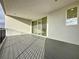 Spacious deck with gray composite decking and glass doors leading to the interior at 9778 Bucklow Hill Dr, Orlando, FL 32832