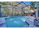 Enjoy this refreshing screened pool with outdoor seating area at 10106 Pink Carnation Ct, Orlando, FL 32825