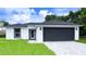 Newly built home with a two-car garage and landscaped lawn at 1030 Darlington Ct, Kissimmee, FL 34758