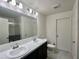 Bathroom with double vanity, marble countertop and shower at 119 Summerlin Loop, Haines City, FL 33844