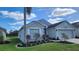 Gray house with landscaping, palm tree, and water view at 1270 Ballyshannon Pkwy., Orlando, FL 32828