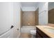 Tiled bathroom featuring a shower-tub combo, vanity, and toilet at 13913 Hahn Ln, Orlando, FL 32827