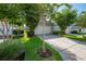 Side exterior of a home featuring the driveway, two-car garage, and lush landscaping at 13913 Hahn Ln, Orlando, FL 32827