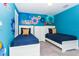 ' bedroom with two twin beds, blue walls, and a fun Mickey Mouse theme at 1648 Moon Valley, Davenport, FL 33896