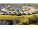 Aerial view of a community with lake and many houses at 17630 Blazing Star Cir, Clermont, FL 34714