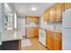 Functional kitchen with wood cabinets and white appliances at 205 9Th St, Saint Cloud, FL 34769