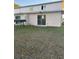 Backyard view of townhouse with small patio and grassy area at 210 Majors Ln # A, Kissimmee, FL 34743