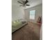 Bedroom with a bed, ceiling fan, and window at 210 Majors Ln # A, Kissimmee, FL 34743