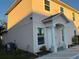Two-story house with light beige walls, white columns, and a paved driveway at 210 Majors Ln # A, Kissimmee, FL 34743