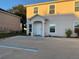 Front view of a two-story house with a white door and parking at 210 Majors Ln # A, Kissimmee, FL 34743