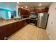 Kitchen with dark brown cabinets, stainless steel appliances, and granite counters at 210 Majors Ln # A, Kissimmee, FL 34743