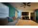 Living room with gray sectional sofa, a large TV, and teal walls at 210 Majors Ln # A, Kissimmee, FL 34743