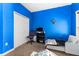 Bright bedroom with blue walls, built-in closet and window at 2121 Black Mangrove Dr, Orlando, FL 32828