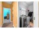 Bright laundry room with washer, dryer, and ample shelving at 2121 Black Mangrove Dr, Orlando, FL 32828