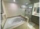 Spa-like bathroom with a large soaking tub and glass shower at 2213 Rio Pinar Lakes Blvd, Orlando, FL 32822