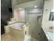 Bathroom with a jetted tub and glass enclosed shower at 2213 Rio Pinar Lakes Blvd, Orlando, FL 32822