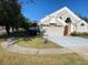 Two-story house with a red door and attached garage, side view at 2213 Rio Pinar Lakes Blvd, Orlando, FL 32822
