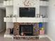 Stone fireplace with built-in shelving and a large TV at 2213 Rio Pinar Lakes Blvd, Orlando, FL 32822