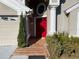 Red double front door with decorative tile entryway at 2213 Rio Pinar Lakes Blvd, Orlando, FL 32822