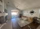 Living room with hardwood floors, comfy couch and access to patio at 2213 Rio Pinar Lakes Blvd, Orlando, FL 32822