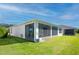 White screened porch with view of backyard and lake at 249 Treviso Dr, Kissimmee, FL 34759