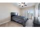 Cozy bedroom with double doors leading to a private balcony at 2789 Kissimmee Bay Cir, Kissimmee, FL 34744