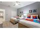 ' bedroom with two twin beds, superhero themed bedding, and ample closet space at 4449 Shiva Loop, Kissimmee, FL 34746