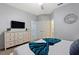 Comfortable bedroom with dresser and queen-size bed at 4449 Shiva Loop, Kissimmee, FL 34746