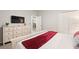 Bedroom with a queen bed, dresser, and view into another room at 4449 Shiva Loop, Kissimmee, FL 34746
