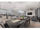 Dining area with a large dark wood table and gray chairs, open to the kitchen at 4449 Shiva Loop, Kissimmee, FL 34746