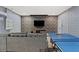 Basement game room with ping pong table and sectional sofa at 4449 Shiva Loop, Kissimmee, FL 34746