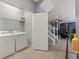Bright laundry room with washer, dryer, and shelving at 4449 Shiva Loop, Kissimmee, FL 34746