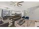 Spacious living room with gray couches, a coffee table, and a large TV at 4449 Shiva Loop, Kissimmee, FL 34746