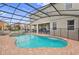 Inviting freeform pool and spa with brick pavers and covered patio at 4449 Shiva Loop, Kissimmee, FL 34746