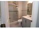 Updated bathroom with walk-in shower and grey vanity at 4971 Pall Mall W St, Kissimmee, FL 34758