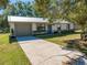 Single-story home with metal roof and a spacious front yard at 6446 Creation St, Saint Cloud, FL 34771