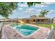 Inviting kidney-shaped pool with brick pavers and solar panels at 814 Starke Lake Cir, Ocoee, FL 34761