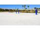 Two sand volleyball courts with blue nets and white sand at 8932 Cabot Cliffs Dr, Davenport, FL 33896