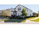 Two-story house with white exterior, brown garage door, and landscaping at 9001 Sunshine Ridge Loop, Kissimmee, FL 34747