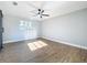 Sunny bedroom featuring hardwood floors and ceiling fan at 905 W 11Th Ave, Mount Dora, FL 32757