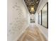 Modern hallway with unique wall art and herringbone wood flooring at 1181 Trappers Trail Loop, Davenport, FL 33896